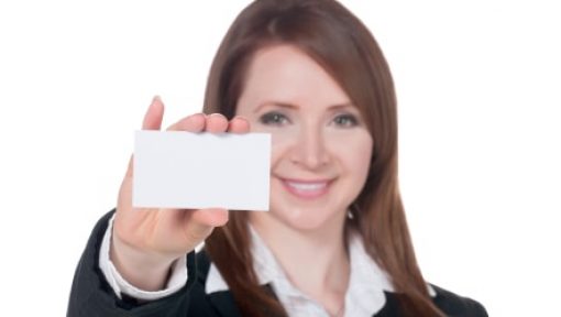a smiling businesswoman holding empty card